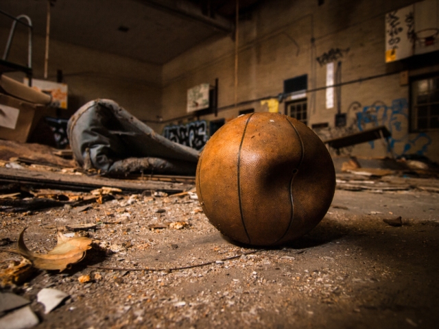 deflated basketball in abandoned gym