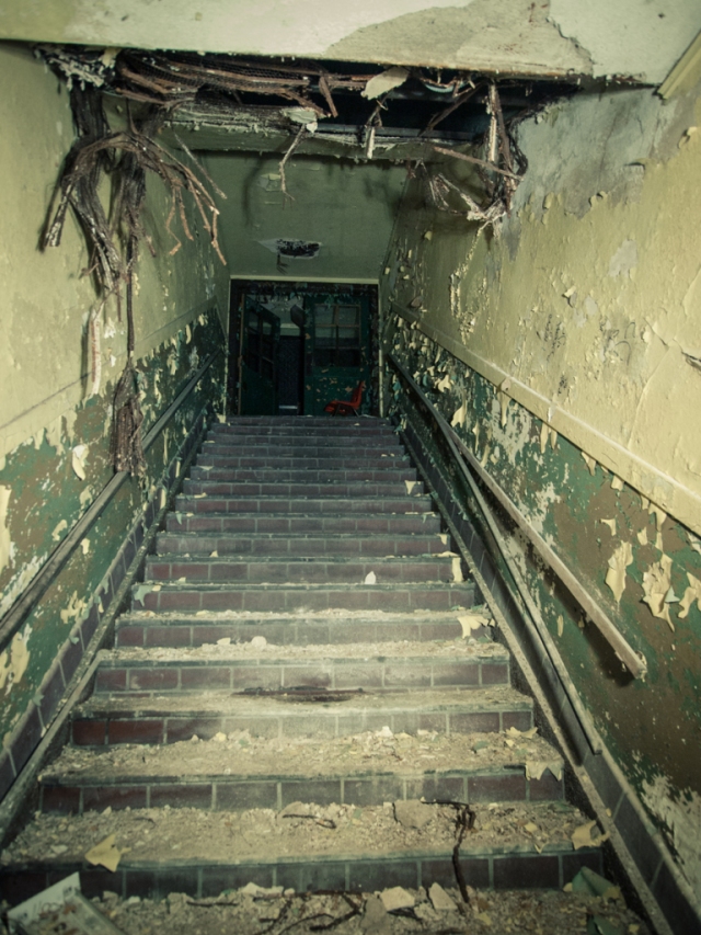 dark creepy stairwell in abandoned school