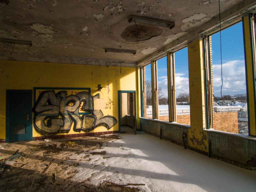 light shining in on yellow walls in abandoned class room