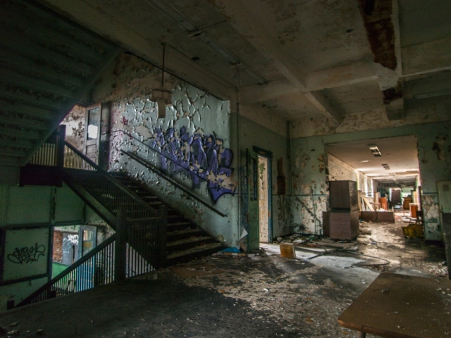 abandoned school hallway with stairwell