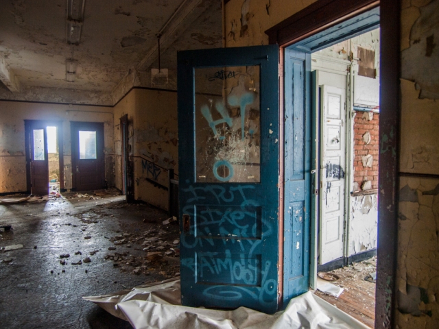 blue door open in abandoned school