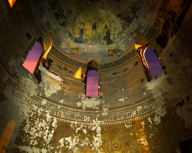 church at night looking up at mural in apse