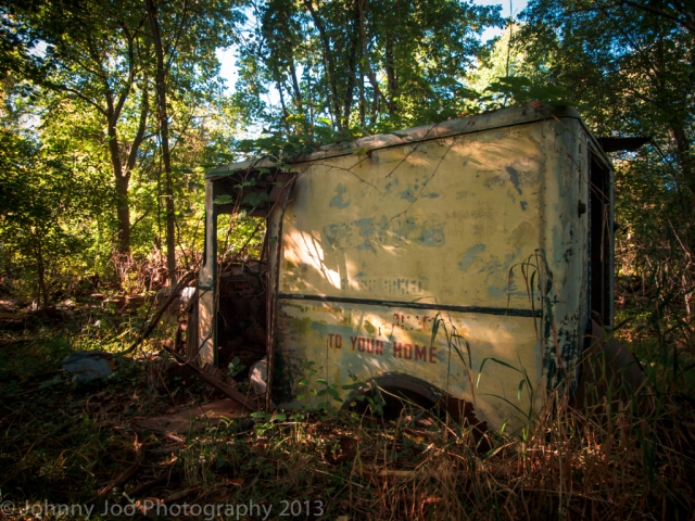 old vintage milk truck in the woods