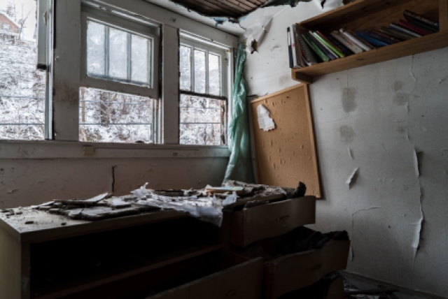 books in room of abandoned house