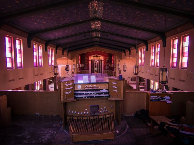 abandoned purple church with organ