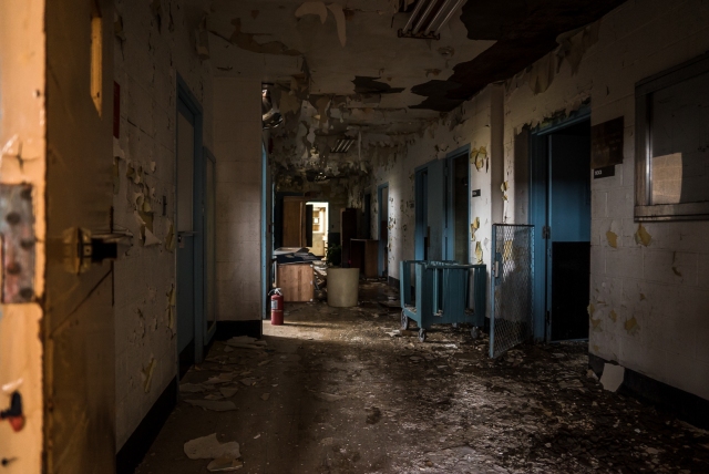 decaying hallway inside abandoned hospital